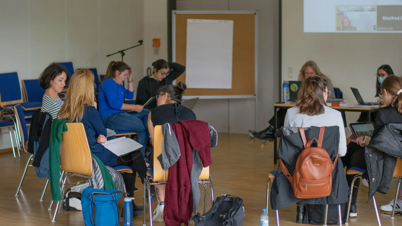 Lehrende und Teilnehmende der Summer School diskutieren im Seminarraum.