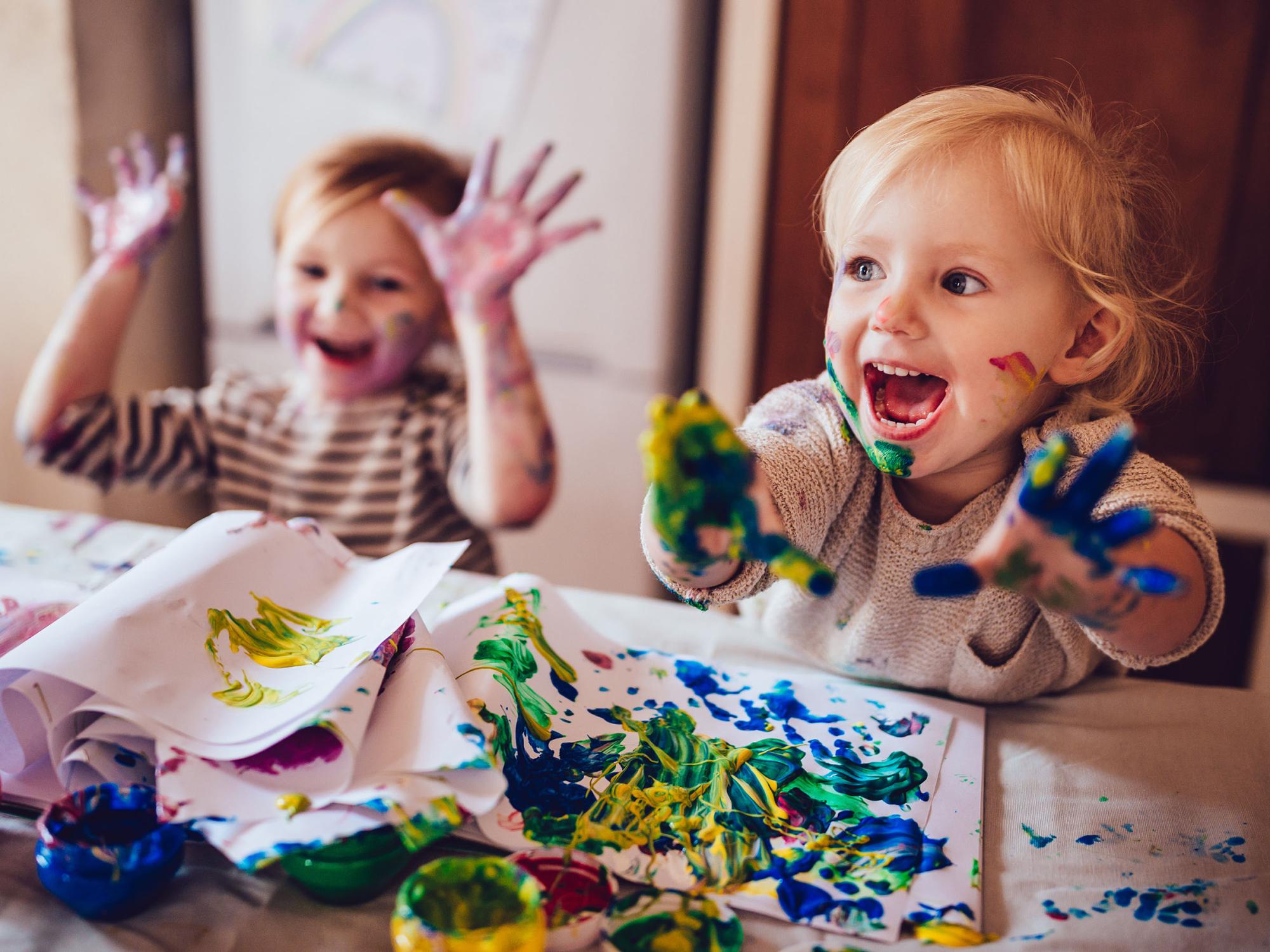 Zwei fr?hliche Kinder beim Malen mit Fingerfarben